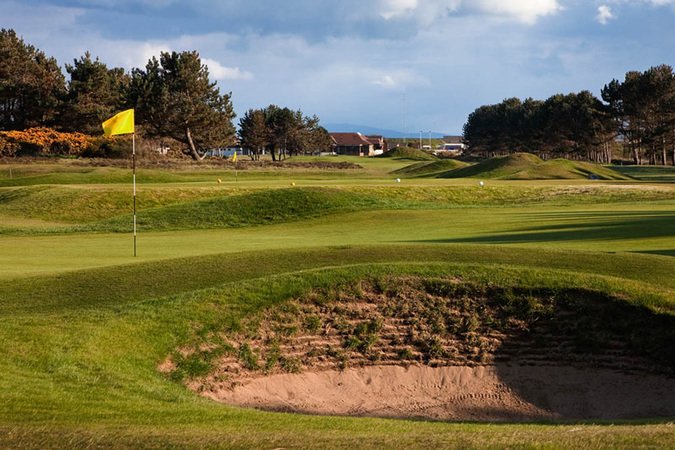 Kilmarnock Barassie Golf Club in Ayrshire, Scotland- Golf green with flag and nearby bunker
