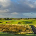 Dundonald Links 11th hole in Ayshire, Scotland. Golf green surrounded by 3 bunkers