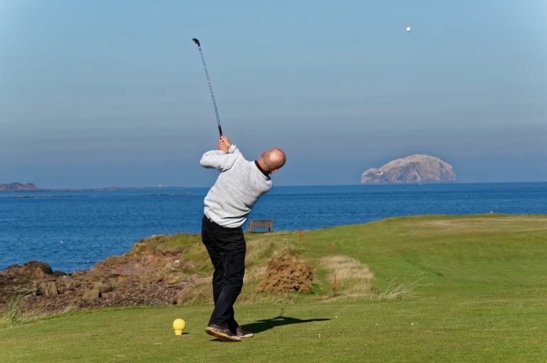 Golfer Tees off in Scotland